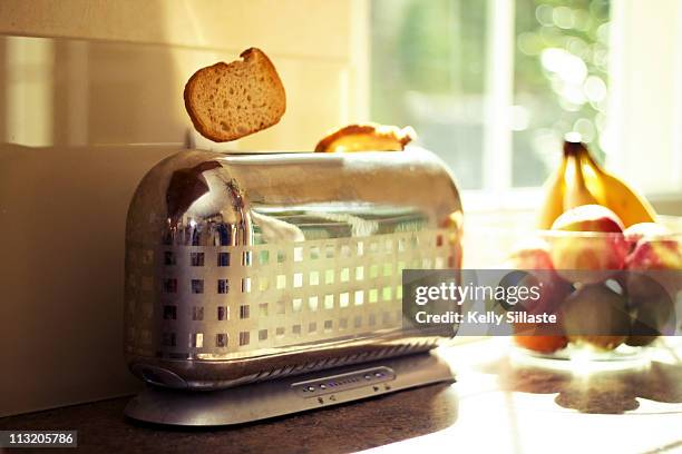 stylish chrome toaster popping up toast - toaster stockfoto's en -beelden