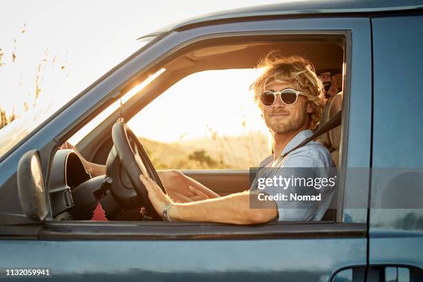 confident man on road trip driving van - sunny window stock pictures, royalty-free photos & images