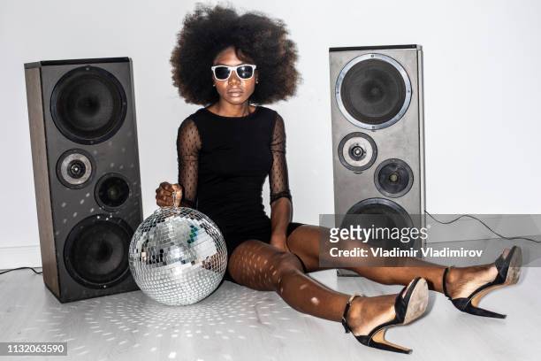 woman in black dress and sunglasses holding disco ball - teen soles stock pictures, royalty-free photos & images