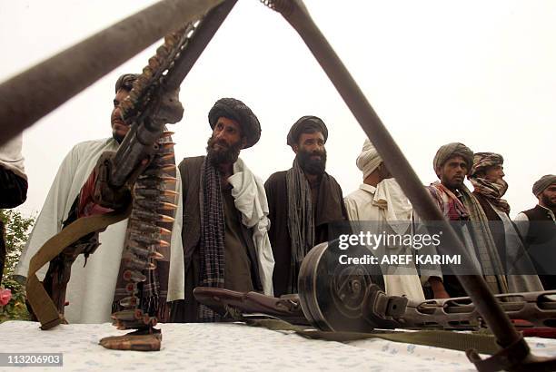 Surrendering Taliban militants stand with their weapons as they are presented to the media in Herat on April 27, 2011. Fifteen Taliban fighters from...