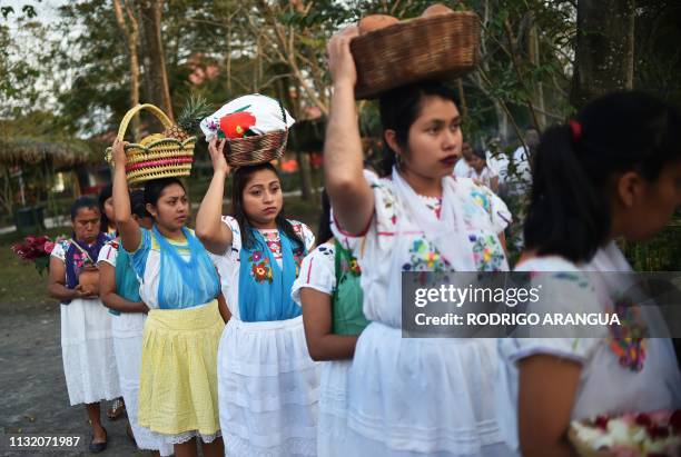 Mexican Totonac natives carry offerings during a ceremony to request permission from the gods, to hold the Tajin Summit Festival -aimed at preserving...