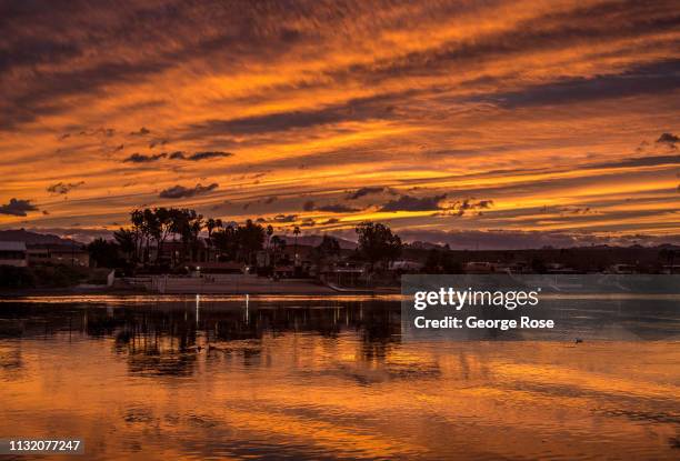 Colorful sunrise over the Arizona side of the Colorado River is viewed from Harrah's Hotel & Casino on February 5, 2019 in Laughlin, Nevada. Located...