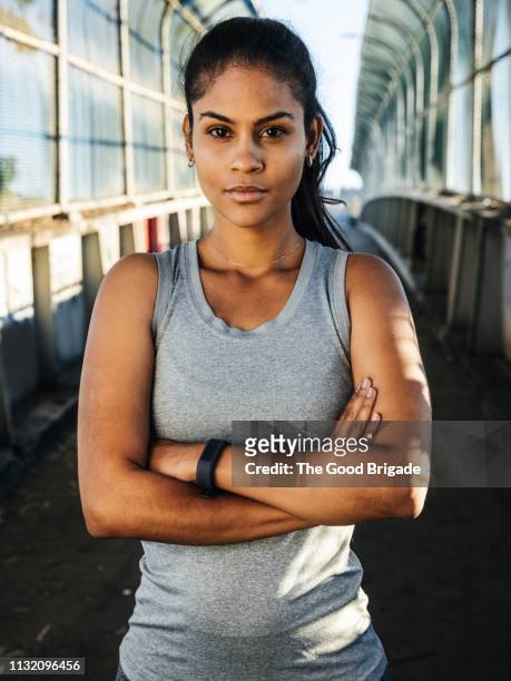 Portrait of female athlete standing on bridge