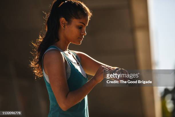female runner using smart watch - run watch stock pictures, royalty-free photos & images