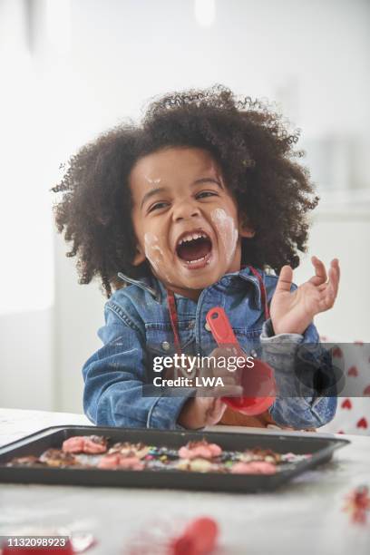 young black boy baking in kitchen. - messy cooking stock pictures, royalty-free photos & images