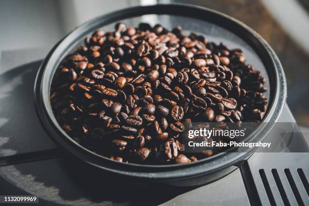 coffee beans in machine - etwas herstellen stock pictures, royalty-free photos & images