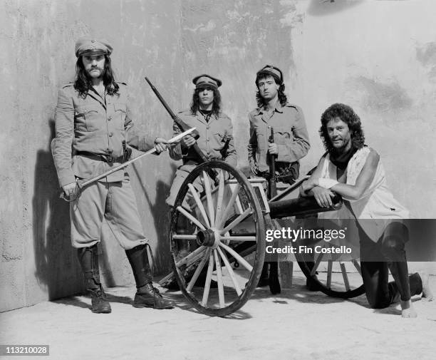 Motorhead pose in military uniforms with a cannon for a photo session for the 'Killed By Death' single cover in Pimlico, London in July 1984. Left to...