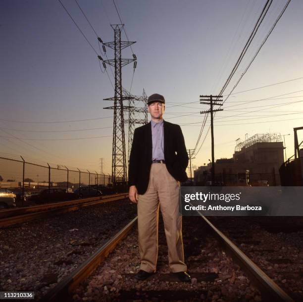 Portrait of American film and television director David Lynch as he poses on railroad tracks, Los Angeles, California, 1989.