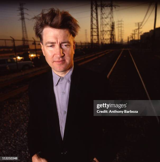 Portrait of American film and television director David Lynch as he poses on railroad tracks, Los Angeles, California, 1989.