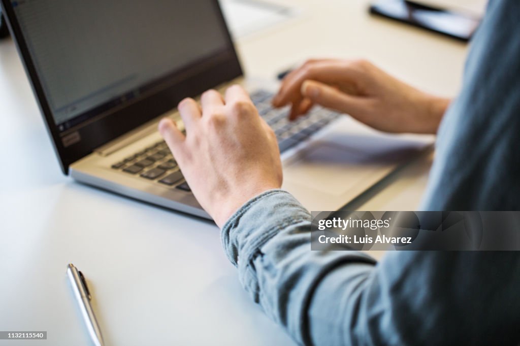 Close up of businesswoman working on laptop