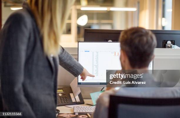 two business people working together on computer - two people at computer stock pictures, royalty-free photos & images
