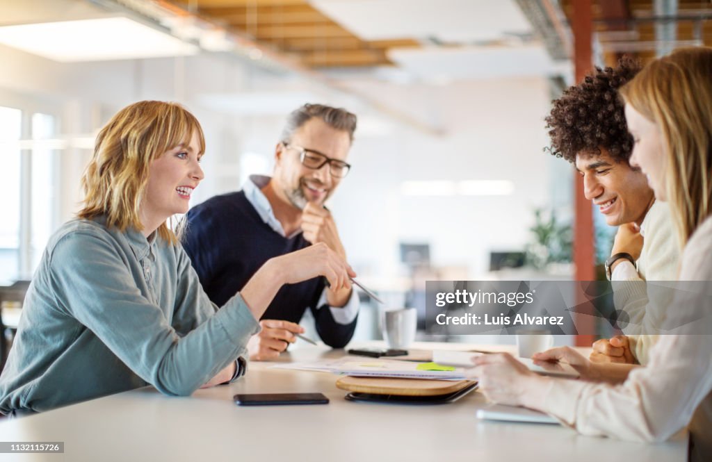 Group of people discussing business plan in office