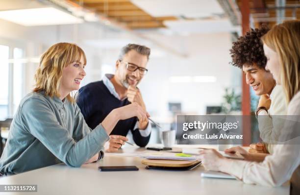 group of people discussing business plan in office - four people talking stock pictures, royalty-free photos & images