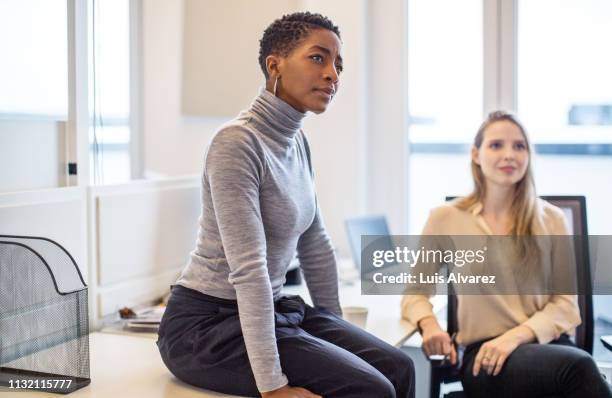 businesswoman paying attention to the discussion - black polo shirt stock pictures, royalty-free photos & images