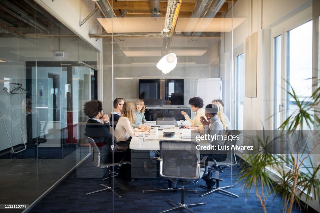 Business people having board meeting in modern office