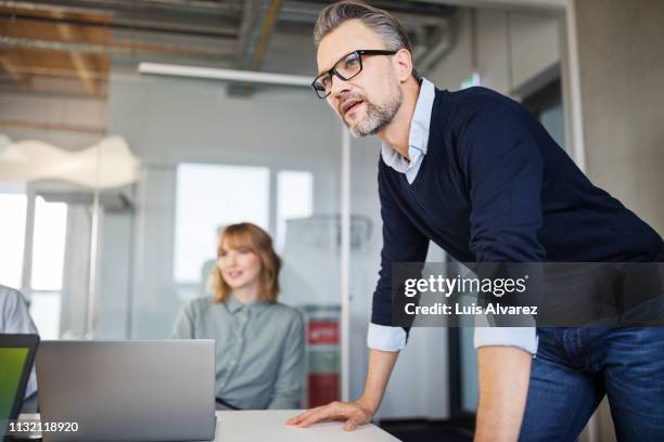 business people having meeting in office - leaning stock pictures, royalty-free photos & images