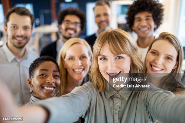 successful business team taking selfie - grupo mediano de personas fotografías e imágenes de stock