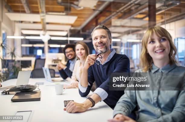 positive business team attending video conference - staff meeting stock pictures, royalty-free photos & images