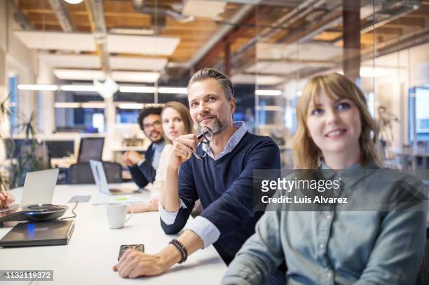 business group attending video conference call in board room - concepts & topics stock pictures, royalty-free photos & images