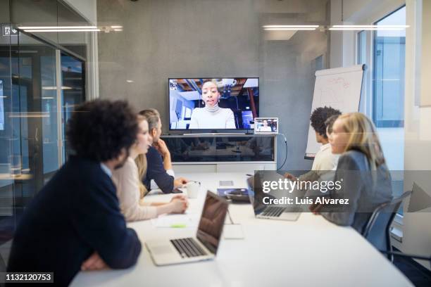 group of business people having video conference - global and technology and business stock-fotos und bilder