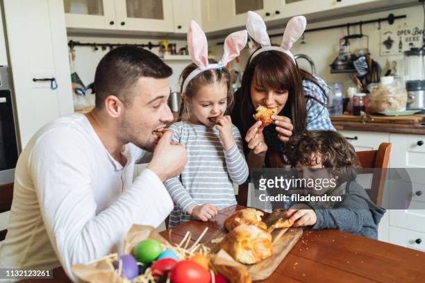 family eating easter bread - sweet bread stock pictures, royalty-free photos & images
