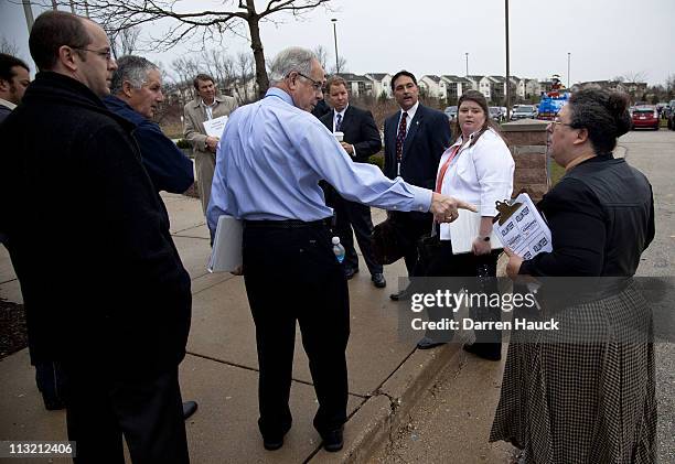 Volunteer for the Kloppenburg campaign talks to members of the Justice Prosser volunteers before members of the Milwaukee County Election Commission...