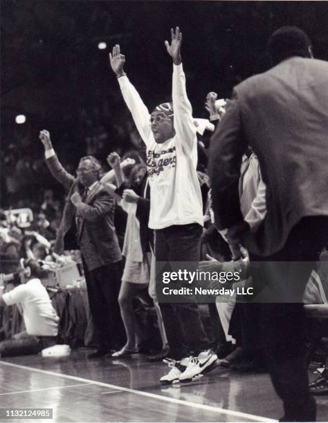 Director Spike Lee cheers the New York Knicks basketball team on to victory at Madison Square Garden in Manhattan on May 23, 1993.