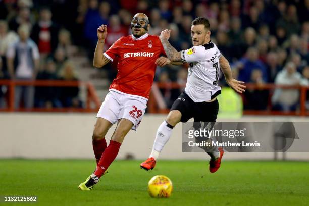Yohan Benalouane of Nottingham Forest is challenged by Jack Marriott of Derby County Sky Bet Championship match between Nottingham Forest and Derby...