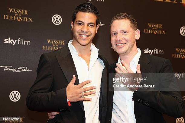 Marco Kreuzpaintner and his partner Gilardi poses with their wedding rings upon their arrival at the 'Wasser fuer die Elefanten' Germany premiere at...