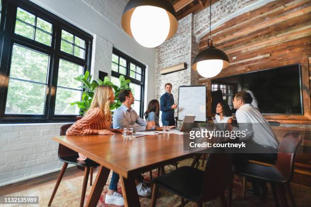 business people watching a presentation on the whiteboard - cool attitude stock pictures, royalty-free photos & images