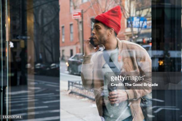 young man window shopping on city street - window shopping stock pictures, royalty-free photos & images