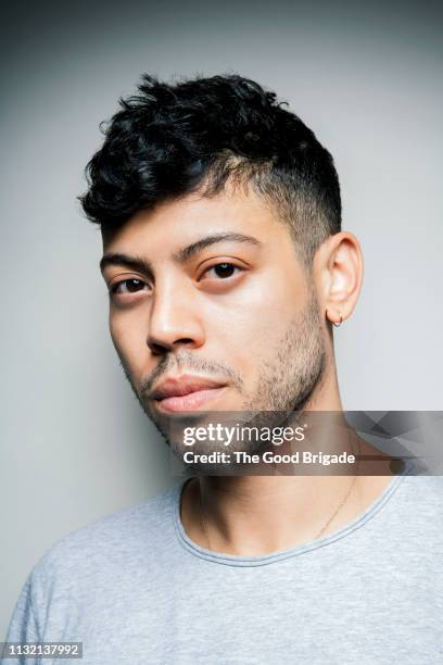 serious portrait of a serious young man in studio - hair stubble stockfoto's en -beelden