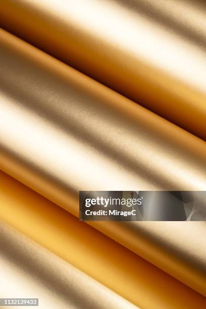 rolled up golden colored texture - gold scroll stock pictures, royalty-free photos & images