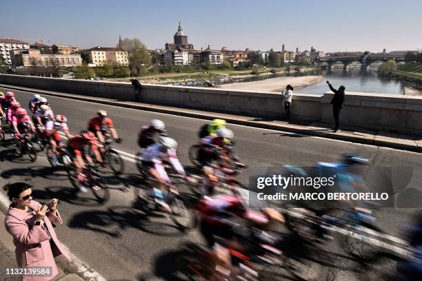 The pack of riders crosses the Ticino river in Pavia, with the 14th - 15th Century Pavia Monastery in background, during the one-day classic cycling...