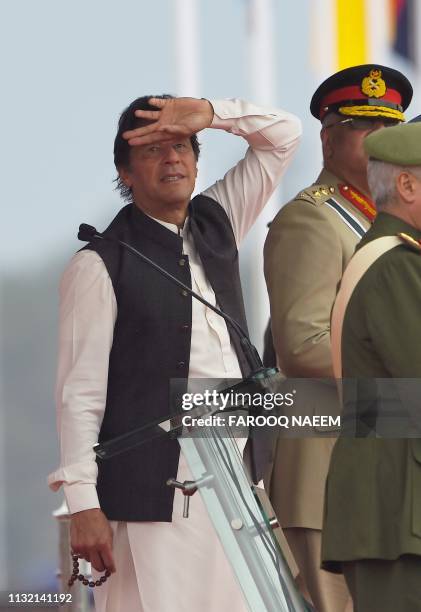 Pakistani Prime Minister Imran Khan look at the fighter jet performance during the Pakistan Day parade in Islamabad on March 23, 2019. - Pakistan...