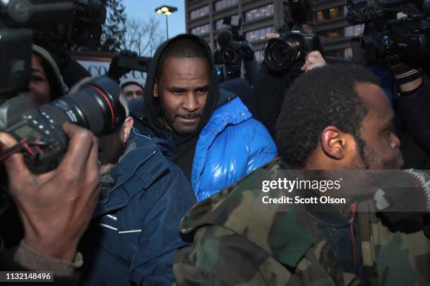 Singer R. Kelly fights his way through photographers outside of the Cook County jail after posting $100 thousand bond on February 25, 2019 in...