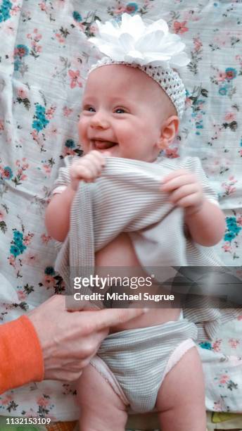 Smiling and happy newborn baby in cute outfit.