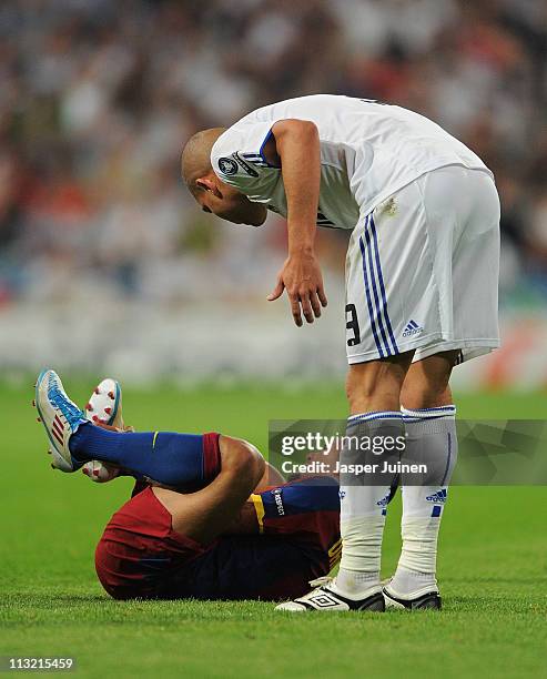 Pepe of Real Madrid stands besides Daniel Alves of Barcelona after he fouled him during the UEFA Champions League Semi Final first leg match between...