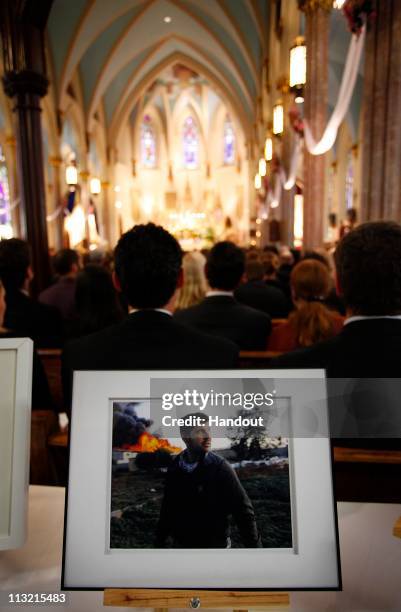 In this handout image provided by Getty Images, A memorial service for Getty Images photographer Chris Hondros takes place at Sacred Hearts of Jesus...