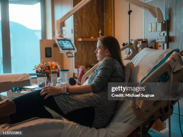 Pregnant woman in hospital bed.