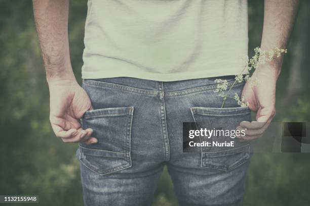 close-up of a man with his hands in his pockets wearing jeans - rear end stock pictures, royalty-free photos & images