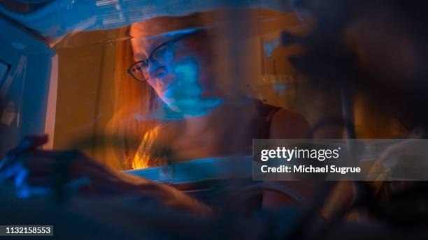 A mother watches her baby in an isolet with hyperbillirubinemia in the neonatal intensive care unit of a hospital.