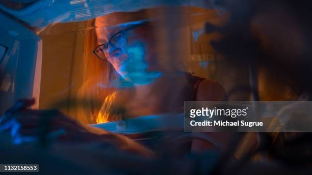 A mother watches her baby in an isolet with hyperbillirubinemia in the neonatal intensive care unit of a hospital.