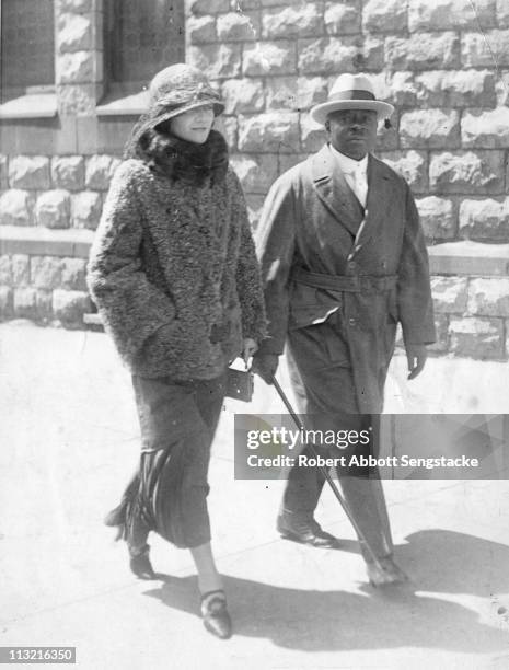 Robert Sengstacke Abbott , founder and publisher of the Chicago Defender newspaper, walks down a Chicago street with his wife Helen, early twentieth...