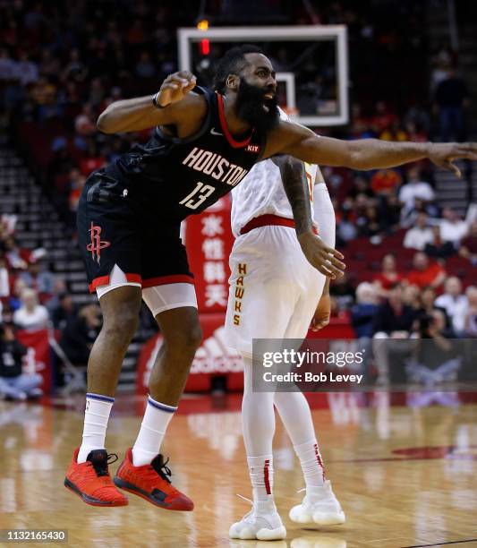 James Harden of the Houston Rockets is fouled by DeAndre' Bembry of the Atlanta Hawks as he shoots during the first quarter at Toyota Center on...