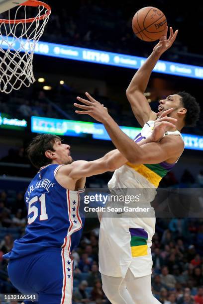 Jahlil Okafor of the New Orleans Pelicans shoots over Boban Marjanovic of the Philadelphia 76ers during the first half at the Smoothie King Center on...