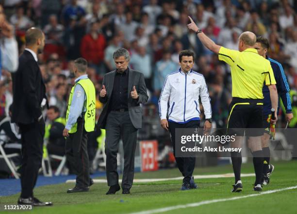 Jose Mourinho the coach of Real Madrid gives a thumbs up to the assistant referee as he is sent off to the stands during the UEFA Champions League...