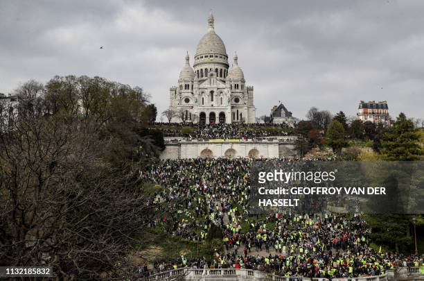 Yellow Vest protesters gather in front of the Sacre Coeur Basilica ontop of the Montmartre hill in Paris on March 23 during an anti-government...