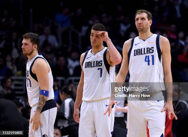 Dirk Nowitzki, Dwight Powell and Luka Doncic of the Dallas Mavericks look on during a 121-112 LA Clipper win at Staples Center on February 25, 2019...