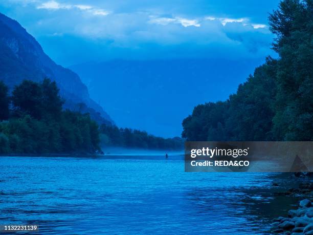 Flyfishing in the fog at Adige river. Vallagarina. Trentino. Italy. Europe.